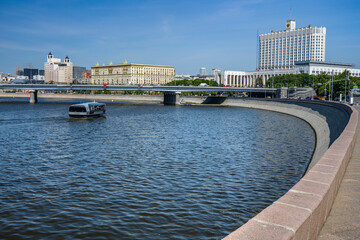 Moscow. Russia. May 24, 2025. View of Smolenskaya embankment, Novoarbatsky bridge, river tram on the Moskva River, Government House on a sunny day.