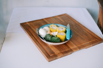 Nutritious food plate arrangement with broccoli corn and hard-boiled eggs