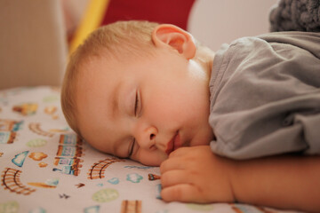 cute little baby sleeping on white blanket. small hands, side view
