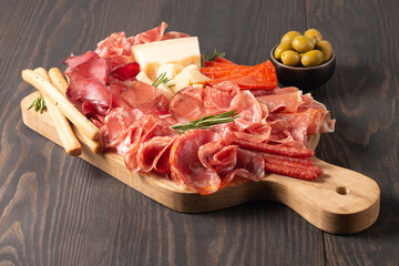 Charcuterie board. Antipasti appetizers of meat platter with salami, prosciutto crudo or jamon and...