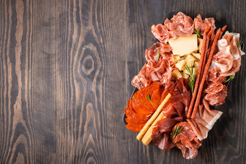 Charcuterie board. Antipasti appetizers of meat platter with salami, prosciutto crudo or jamon and...