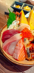 Kaisen don (Rice bowl with sashimi) in Japanese style meal, raw tuna, raw salmon, raw scallop, sweet egg, salmon roe, on sushi sour rice in Japanese restaurant