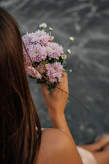 Delicate coastal details with a single flower, female feet by the sea, and a bouquet held at sunset. Peaceful, romantic seaside moments in soft natural light.