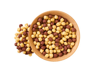 corn balls  and chocolate corn balls pouring out of wooden bowl isolated on white background. Top view.