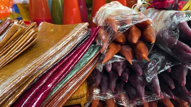 Horizontal 4K video. Sweet shop on Tbilisoba fair, harvest holiday, New Year festival. Stall with multicolored georgian dish juicy red churchkhela on table on street store. Health food, diet, sale