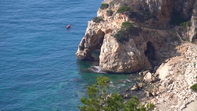 Slow motion, coastline with Cova dels Arcs, in Cala Moraig, Comunidad Valenciana (Spain).