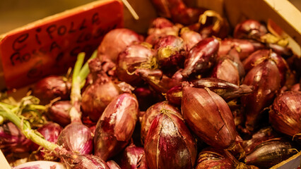 Fresh red onions, also known as Tropea onions, for sale at a market in Calabria, Italy