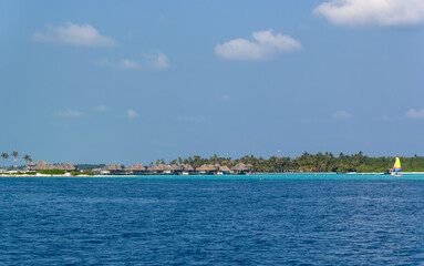 Overwater bungalows provide luxurious island retreat.