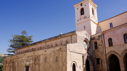 The imposing Norman Cathedral stands tall against the blue sky, showcasing its unique architecture...