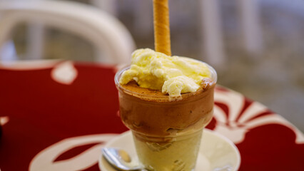 Traditional italian tartufo ice cream served in a glass with a wafer in Tropea, Calabria, Italy