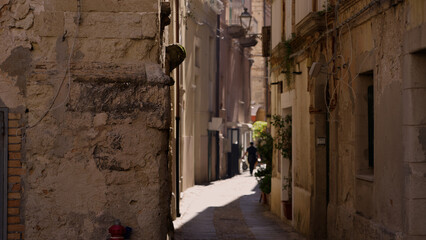 Sun drenched alley in Tropea, Calabria, highlighting the historical architecture and serene atmosphere of Southern Italy © 4kclips