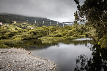 highway bridge in rainy cloudy landscape
