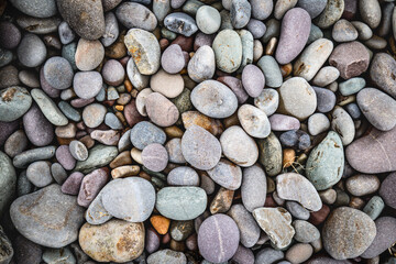 close up of colorful pebbles on the beach, natural pattern