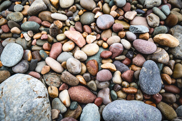close up of colorful pebbles on the beach, natural pattern