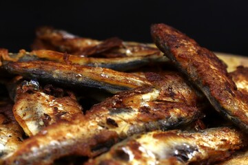 Small fried fish close-up. High-calorie food.