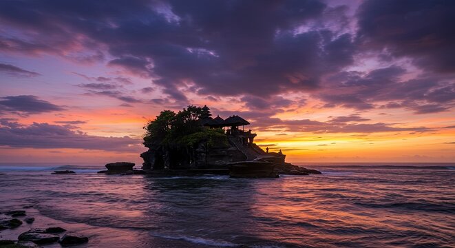 Majestic sunset over Tanah Lot Temple, Bali, showcasing vibrant colors and ocean views.