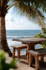 Tropical beachfront wooden table with ocean view under palm trees
