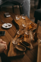 A cozy tea ceremony setting with glass teacups, wooden tray, and warm lighting. Calm atmosphere, mindfulness, and traditional tea preparation in a modern interior.