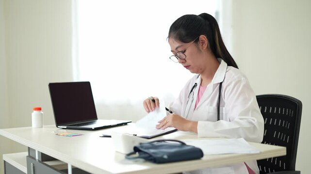 Pain body muscles stiff problem, an asian young doctor is having the back, hand and neck, pain after duty and hand holding and rubbing hurt area, professional with problem in health due to overworked.