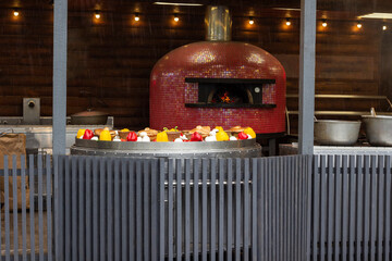 Large frying pan with grilled vegetables. Oven with open fire.
