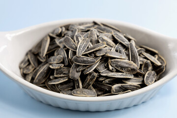 Roasted salted sunflower seeds in a white bowl
