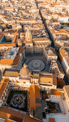 Fototapeta premium Aerial view of Piazza Pretoria in Palermo, Sicily, with its iconic fountain, baroque buildings, and the dome of San Giuseppe dei Teatini glowing in warm morning light