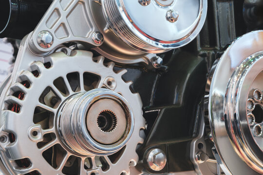 close up of a car engine with a lot of detail. The engine is a complex piece of machinery with many parts and components. Concept of awe and admiration for the engineering and design of the engine.