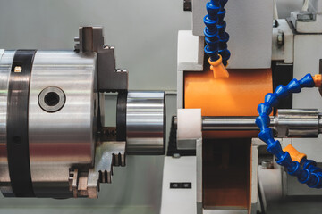 Industrial metalworking lathe type machine grinding round metal part, industrial concept background