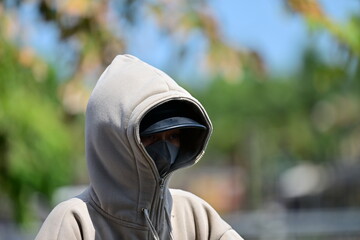 A young, completely sun protected woman in Hoi-An-Vietnam on a hot summer day.