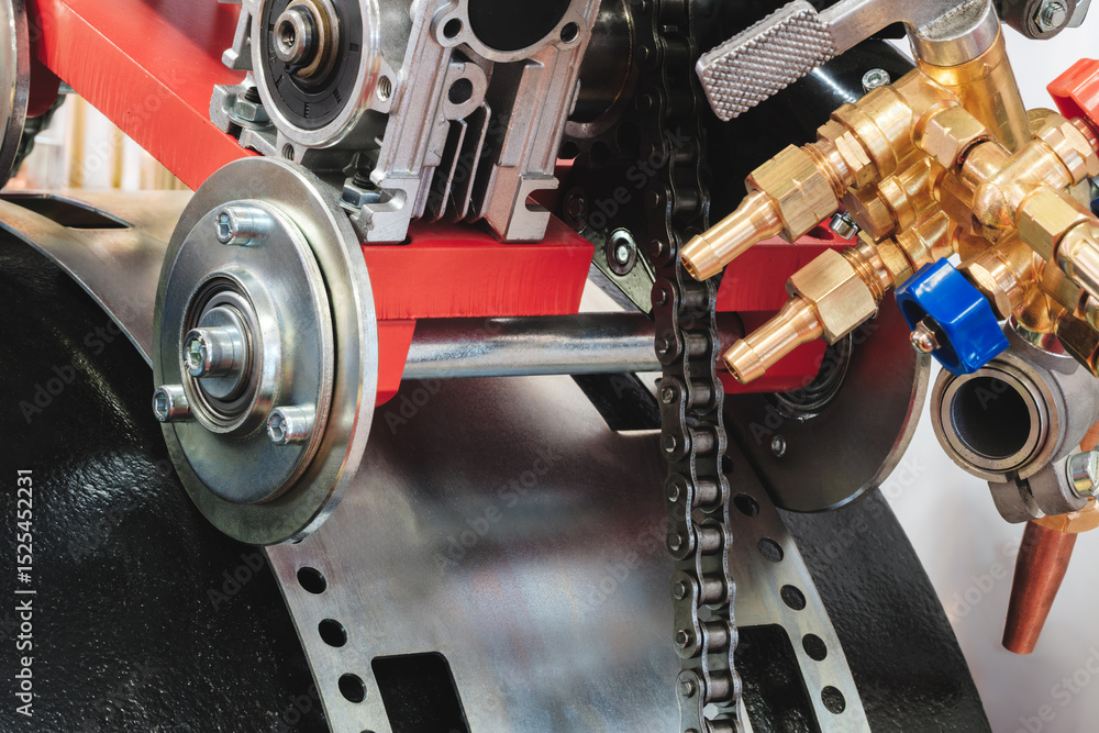Aufkleber A chain is attached to a red engine. The chain is made of metal and is attached to the engine