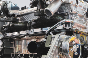close up of a car engine with a lot of detail. The engine is a complex piece of machinery with many parts and components. Concept of awe and admiration for the engineering and design of the engine