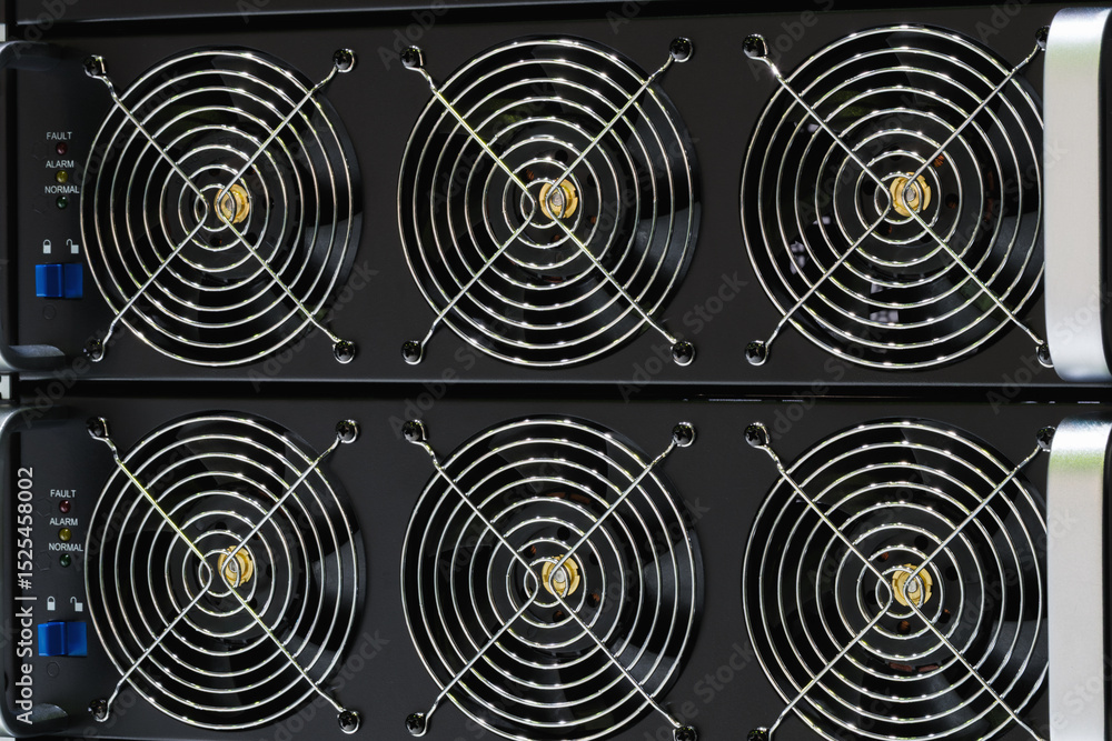 Poster a black computer tower with a large fan on the top. the fans are black and silver. the tower is made