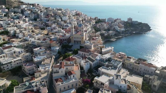 Greek island of Syros, blue roof of the church, embankment, city center. Video dji