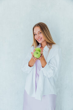 Beautiful woman holding green fragrant apples for diet