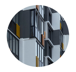 Building facade with geometric pattern featuring yellow and grey panels, round decorative elements,