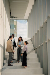 Business people talking on stairs in modern office building