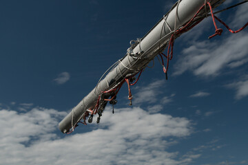 Bowsprit with red cables  reaches for blue skies - 1