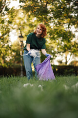 Young woman picking up trash in a public park