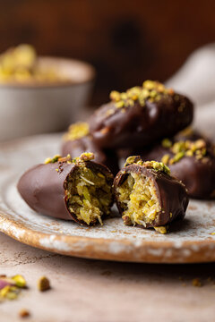 Dates filled with crunchy pistachio cream and covered in chocolate, Dubai chocolate dates. AI Generative