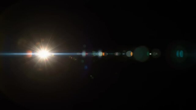 Abstract video of a bright light with lens flare effect on black background overlay