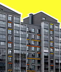 Contemporary apartment building with bright orange and yellow accents on geometric facade. Modern
