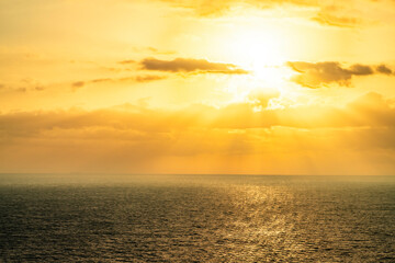 Golden sunrise over the sea with dramatic clouds