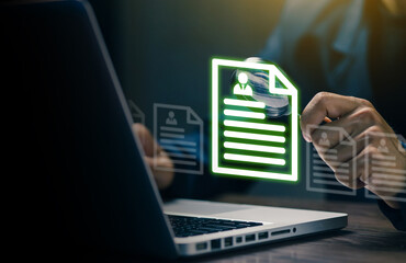 Businessman analyzing digital resume files on a laptop screen, symbolizing online recruitment, HR management, and digital document processing.