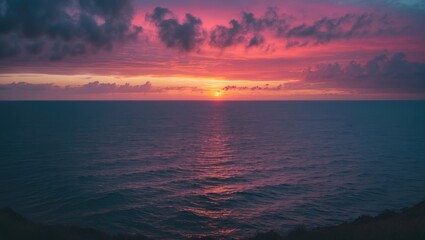 Fototapeta premium Sunset over the ocean with vibrant clouds and a colorful sky.