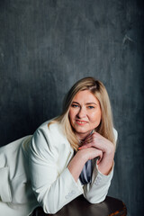 Fototapeta premium 40 years old woman in white business suit at work