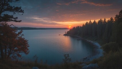 A tranquil lake scene at sunset with trees along the shoreline and a colorful sky.