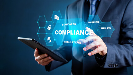 Obraz premium Businessman Using Tablet For Compliance Standards Policies And Regulations Concept