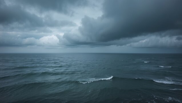 Dark stormy clouds over the ocean, with turbulent waters and rolling waves. Weather and nature, stormy sea, dramatic sky. The scene of a stormy ocean.