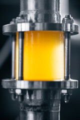 Control window of Industrial beer flow in stainless steel pipe at brewery