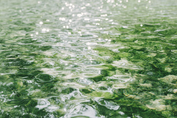 serene scene of crystal clear water in lake with ultrabright light reflections dancing on surface